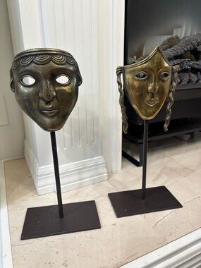 Pair of vintage brass theater masks on metal stand